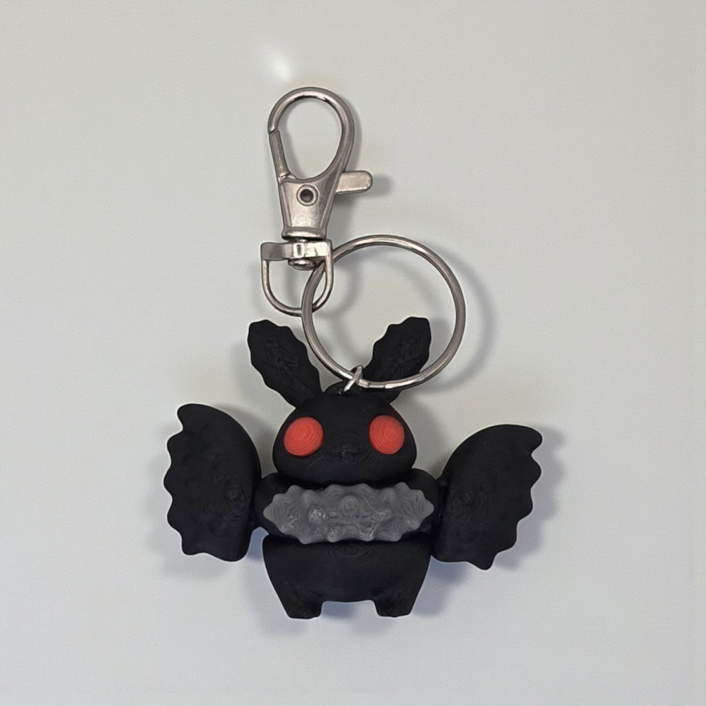 dolibarr:1412:BCL-AC-KEY-MMAN-Mothman KeychainSQ-Photoroom.jpg:sha256=6406dfbd0365