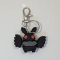 dolibarr:1412:BCL-AC-KEY-MMAN-Mothman KeychainSQ-Photoroom.jpg:sha256=6406dfbd0365